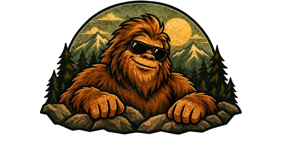 Squatch grinning and leaning on a rocky ledge, wearing sunglasses